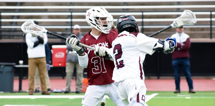 Golden junior Dylan Mathias (31) tries to get off a shot as Cheyenne Mountain sophomore Zak Paige closes in during the first quarter Monday, May 20, at All-City Stadium. Mathias is one of a host of key returning players for the now defending Class 4A boys lacrosse state champions