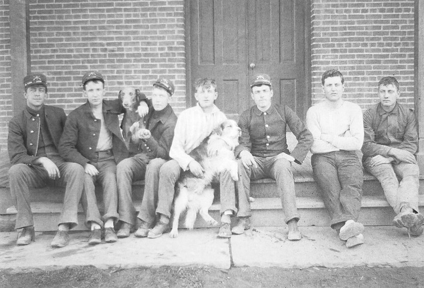 Troops sit on the porch of a barracks building in the early years of the 20th century. Courtesy of Friends of Historic Fort Logan