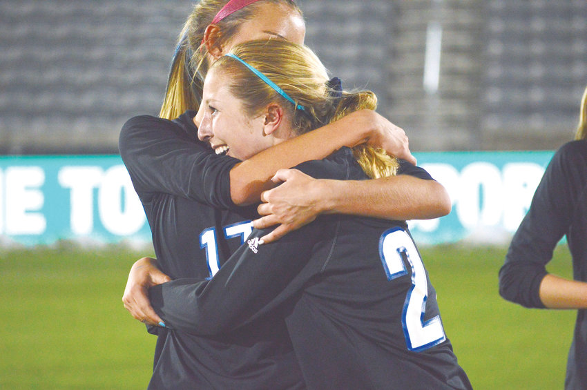 Lauren Holleran (17) hugs (22) Skyler Whitcher as Grandview's girls soccer team defeated Arapahoe 2-1 on May 22 at Dick's Sporting Goods Park to win the Class 5A state championship.