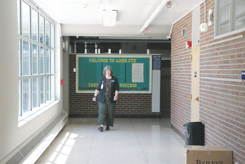 Littleton Public Schools Assistant Superintendent Diane Doney walks down a hallway in the old Ames Elementary School building, which is slated for demolition to make way for a replacement. The school closed in 2008 and has been home to a preschool and Meals on Wheels program since then.