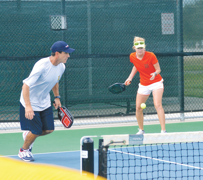 Donnie Gallegos and his wife Patty, mixed-doubles players , compete in pickleball during a recent game. “We started playing and we got addicted to it,” Patty Gallegos said of pickleball.