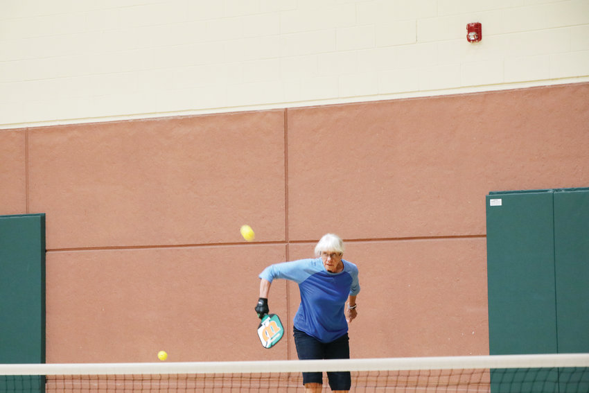 Emmy Patchett makes a return during a July 25 pickleball game at Malley Senior Recreation Center. There were doubles teams playing on both Malley courts and other teams waiting their turn to play the game that is reported to be among the fastest growing sports in the U.S.