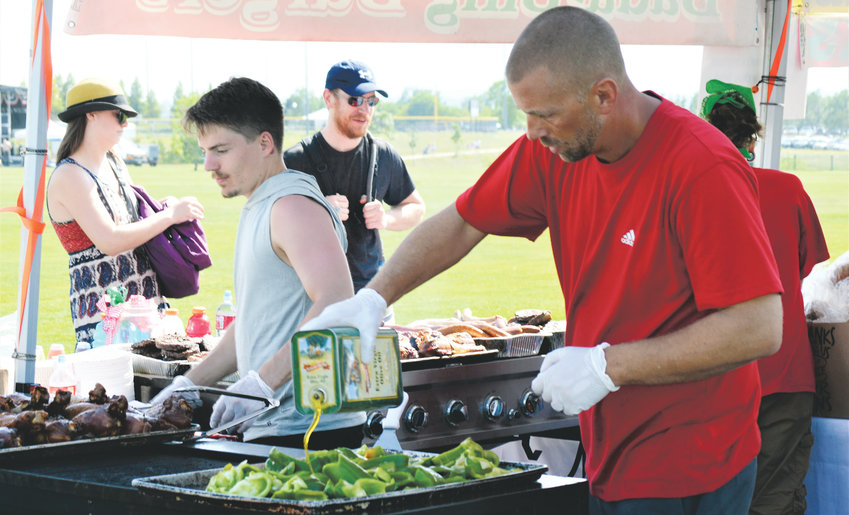 Josh Ikemire of Grammy’s Goodies cooks a grill full of green peppers July 4 at Westminster’s Fourth of July Celebration at Westminster’s City Park. The Grammy’s Goodies stand was one of the dozens of food vendors and trucks that attended the festival to feed music and fireworks spectators.