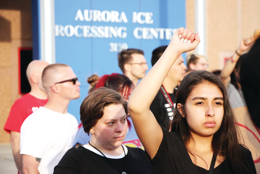 Protesters gather outside the GEO Group immigrant detention facility in Aurora.