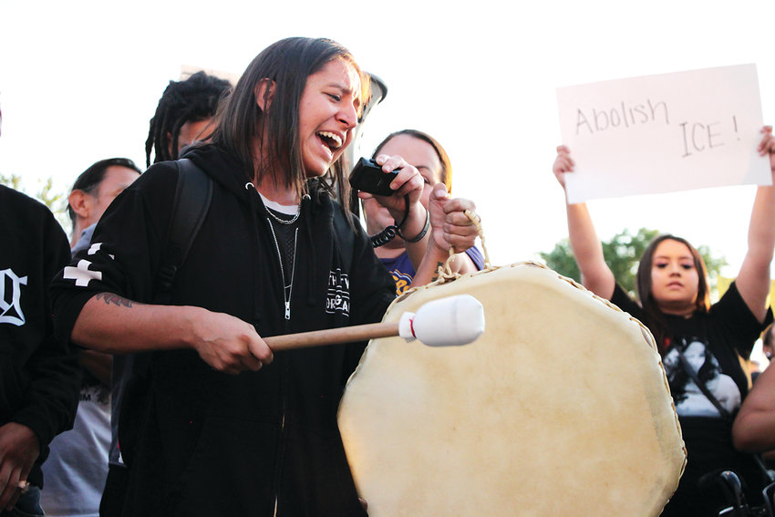 Indigenous rights activist Thomas Lopez Jr. sings in the Lakota language outside Aurora's immigrant detention center.