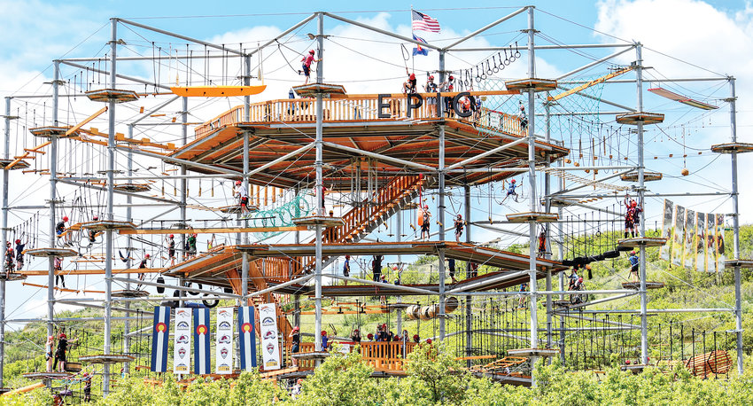 A crowd enjoys Castle Rock Adventure Park’s newest attraction, the 50-foot high Sky Trek, which features 120 different obstacles.