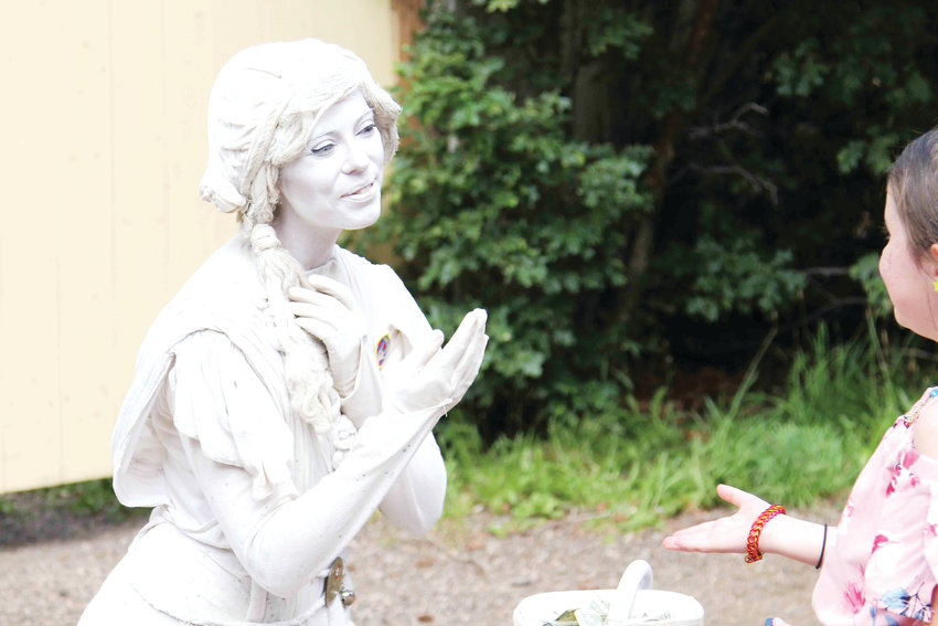 Women portraying statues entertain guests at the Colorado Renaissance Festival.