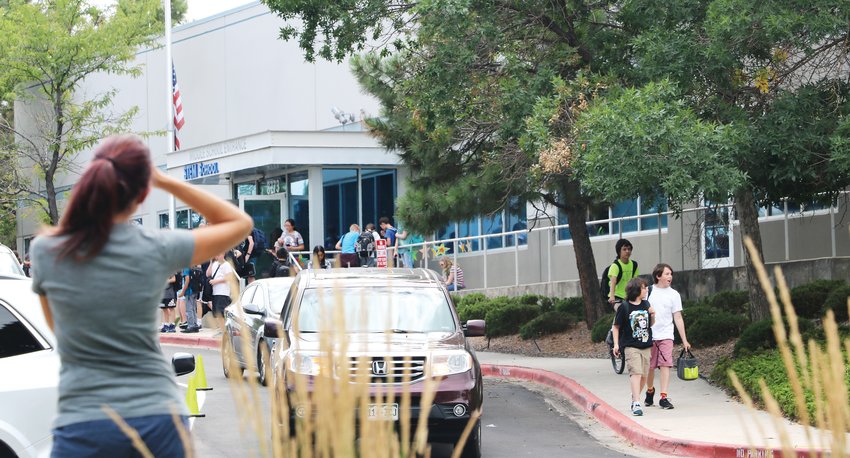 Parents pick up their children from the first day of school at STEM School Highlands Ranch on Aug. 7. The school has increased security and mental health resources following the May 7 school shooting.