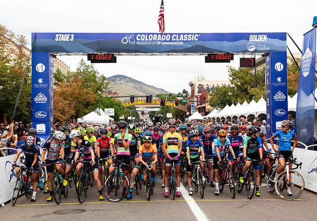 The top racers are introduced to the crowd before the race, with Chloe Dygert-Owen (yellow jersey and pink shoes) at the center.