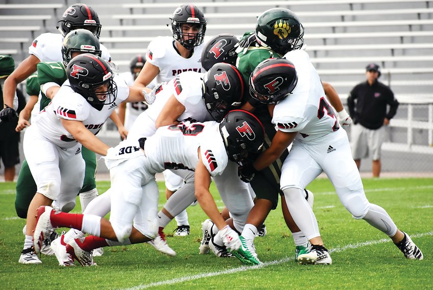 A host of Panthers take down Bear Creek junior Adrian Valenzuela during a first-quarter kickoff Friday, Sept. 6, at Jeffco Stadium. Pomona bounced back with a victory after a tough Week 1 loss to Regis Jesuit.