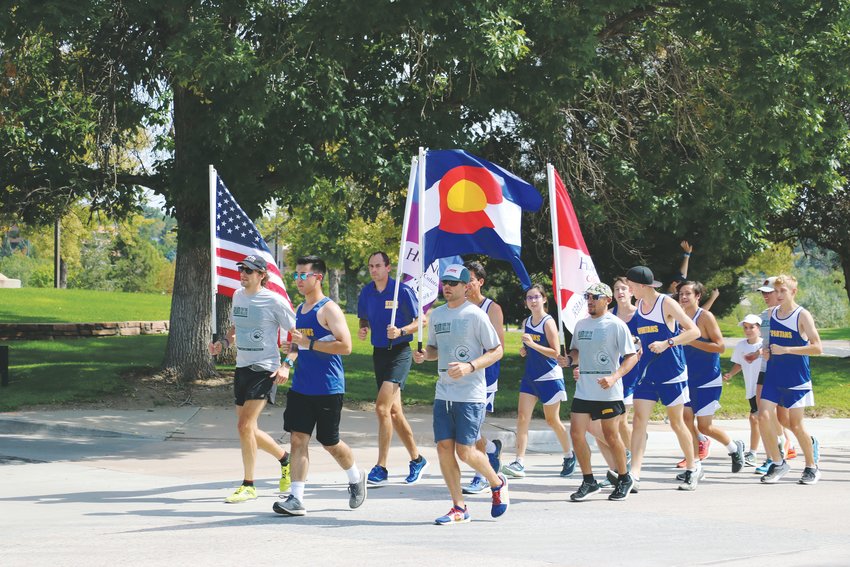 Runners in blue, from STEM’s cross-country team, joined volunteers from Run For the Fallen during the tribute for Kendrick Castillo, who was killed in the May 7 STEM shooting. They ran the mile dedicated to Kendrick with the volunteers.