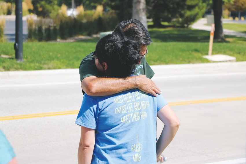 John Castillo hugs his wife, Maria Castillo during the Run For the Fallen event Sunday, Sept. 15. The couple wears matching shirts identifying them as the teen’s parents. The back of the shirts say “Most people go their entire life and never meet their hero, I raised mine!”