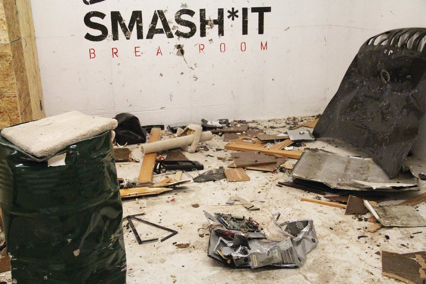 The wreckage after a family used a room at Smash It Breakroom in Denver. A computer, cat tree, car hood and video-game guitar controller are among the discarded objects the family smashed.