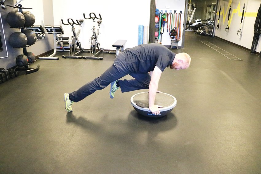 Davis shows how to do “mountain climbers” using a Bosu ball. Broc Thompson, coach of the Jeffco ski team, recommends using this tool with multiple exercises to increase stability, he said.