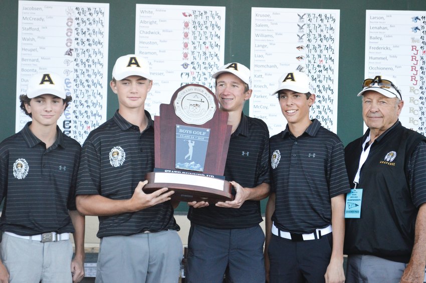 The Arapahoe boys golf team holds its second-place trophy at the Boys State High School Golf Championships held at Pinehurst Country Club.