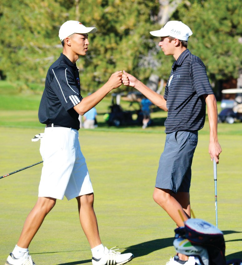 Lakewood's Ryan Liao, left, and Arapahoe's Will Kates congratulate each other after finishing on the 18th hole on Oct. 8 during the final round of the Colorado High School Boys Golf Championships at Pinehurst Country Club. Kates was the individual state champion after rounds of 71 and 66 to finish at 3-under-par 137. Liao tied for third following two rounds of 72.