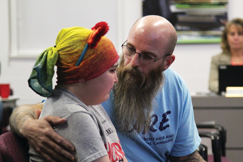 Marley Porter, 14, becomes emotional as her father, Mark, consoles her at the Nov. 12 Douglas County School Board meeting.