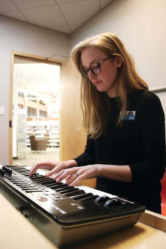Arapahoe Libraries technology specialist Kate O’Brien plays a tune in Southglenn Library’s recording studio.