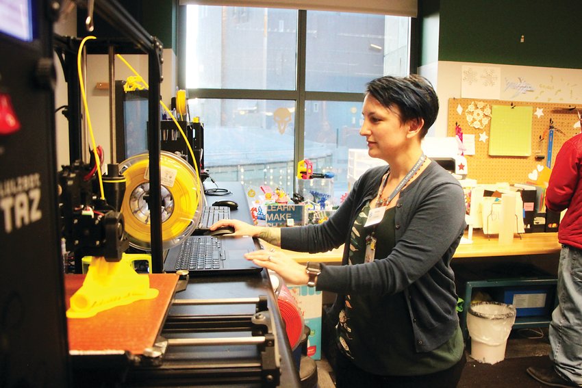 Ashley Kazyaka checks on the progress of a 3D-printed tent pole connector at the Denver Public Library Central Branch’s IdeaLAB makerspace. Kazyaka oversees the district’s makerspace program, which gives patrons access to a wide variety of tools and machinery.
