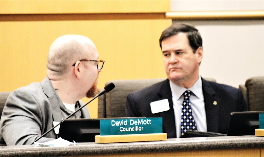 Westminster City Councilors David DeMott and Rich Seymour confer during a public hearing on developer Oread Capital's Uplands development project Feb. 11 at the Westminster City Council. Councilors voted to approve three zoning definition changes for the project which ultimately hopes to build more than 2,300 dwelling units on land surrounding the Pillar of Fire Church at 84th and Lowell Boulevard.