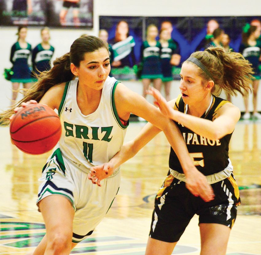 ThunderRidge senior Kristina Keefe, left, is defended by Jayden Staab of Arapahoe during a second-round Class 5A girls state playoff basketball game on Feb. 28 at ThunderRidge. Arapahoe outscored the Grizzlies 15-5 in the fourth quarter and earned a 43-32 victory.