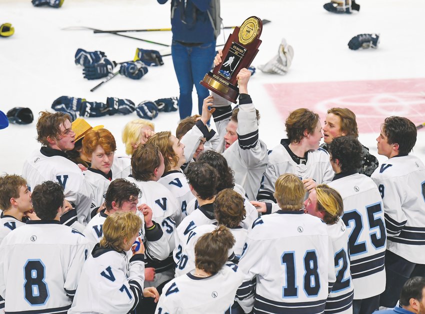 Valor Christian's hockey team celebrates mid-ice as senior captain Mason Hoehn (10) raises the trophy.  It took nearly four hours and five OT periods for the Eagles to score 1-0 on March 10 at the Pepsi Center.
