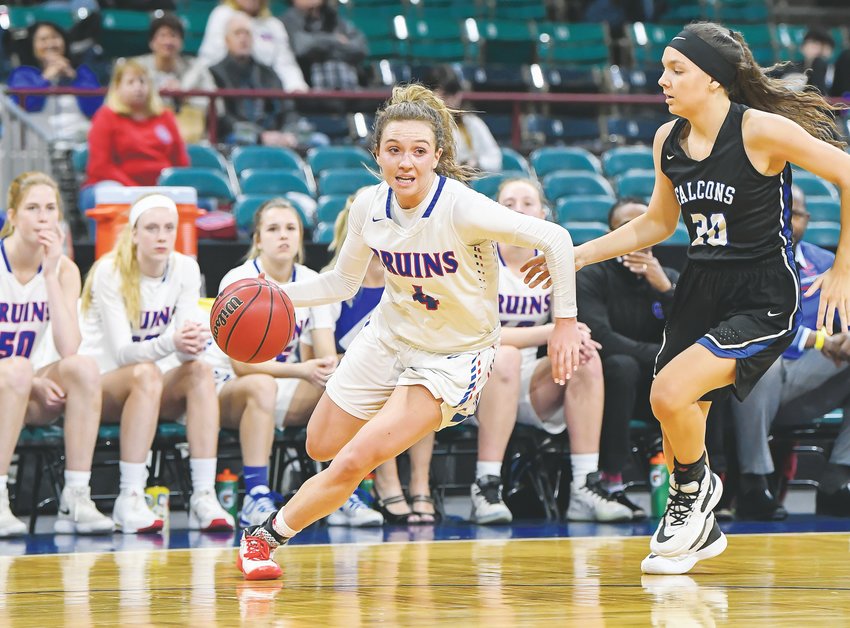 Cherry Creek's Jana VanGytenbeek (4) drives to the hoop as Highlands Ranch's (20) Sara Mitchell pursues.  The Bruins ended up on top 55-42 in Final Four action March 12 at the Denver Coliseum.