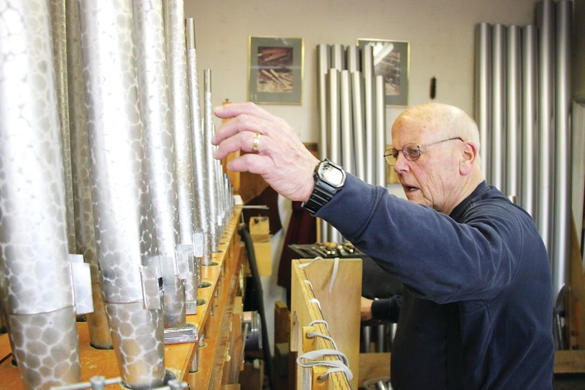 Rick Morel, a third-generation pipe organ builder, checks the tuning on a restoration job from Littleton’s St. Mary Catholic Parish. Pipe organs were once staples of American life, but have begun to fade in recent decades, Morel said.