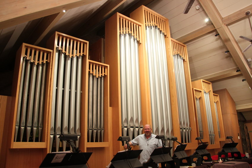 Michael Zehnder stands in front of the 1950s-era Neo-Baroque pipe organ at Ascension Lutheran Church in Littleton.