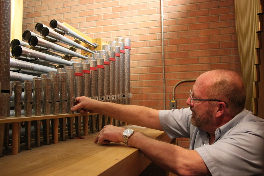 Michael Zehnder inspects some of the smaller pipes inside Ascension Lutheran Church's pipe organ.