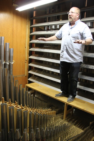 Michael Zehnder stands inside Ascension Lutheran Church's pipe organ.