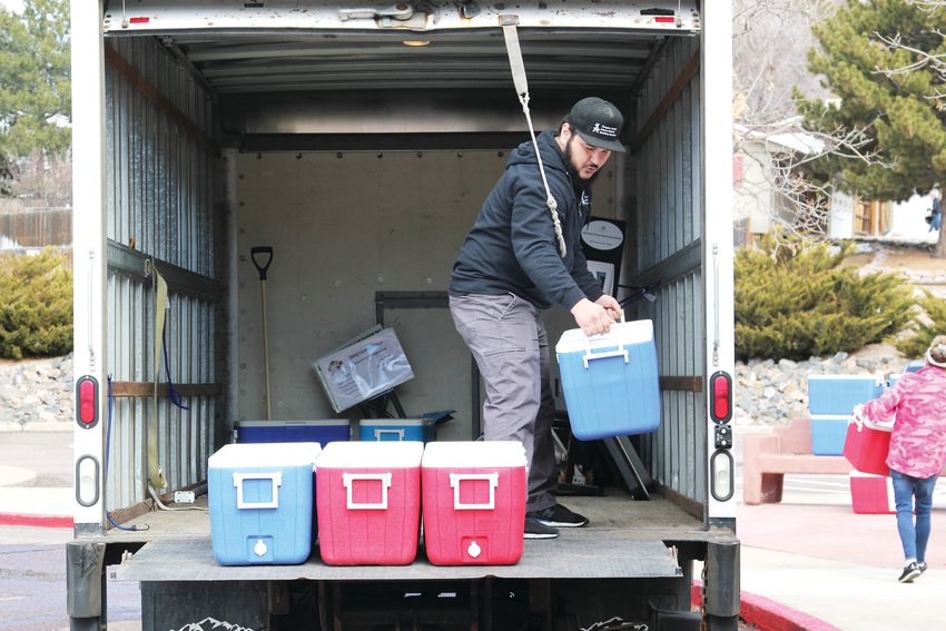 Douglas County School District staff unload coolers full of lunches on March 23, the first day the district offered free lunches to children while schools are closed amid the COVID-19 pandemic.