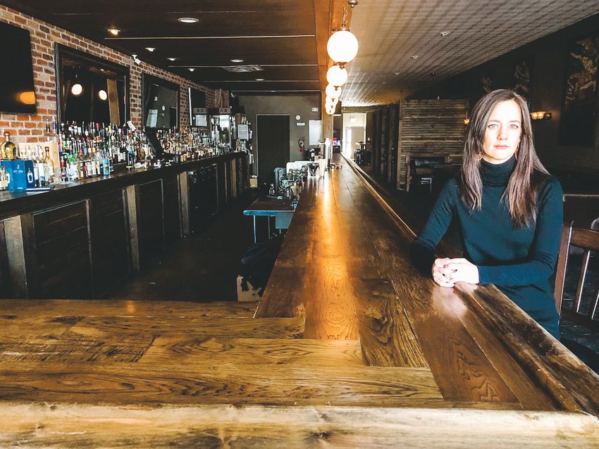 Erika Zierke sits inside the Englewood Grand bar. The bar elected to close before official orders from the state, Zierke said, as a way to flatten the curve of the COVID-19 pandemic and be cautious. The bar doesn't plan to offer to-go orders for the time being.