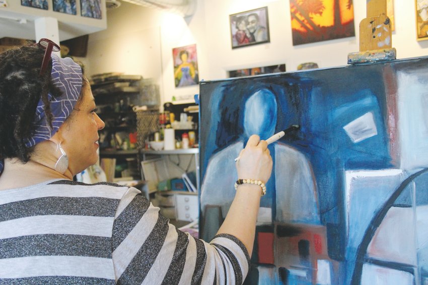Tabetha Landt, owner of the Landt Creative Space art studio in the 40 West Arts District works on an untitled piece. Landt teaches art classes and has moved all of her classes online.