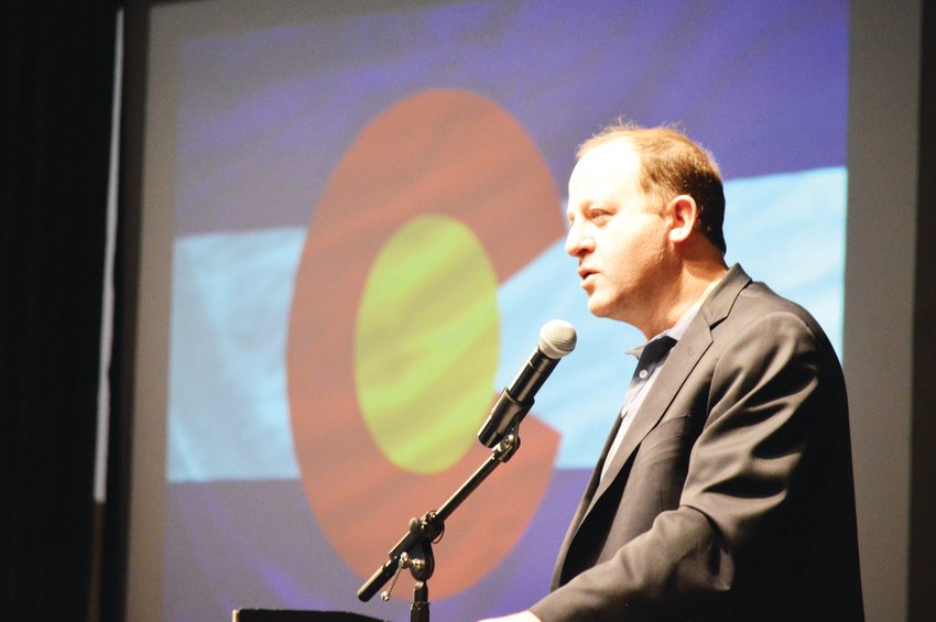 Colorado Gov. Jared Polis, shown here in January, gave an April 15 presentation that said a ban on large gatherings will likely continue for months.