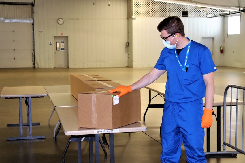 Site manager Bartosz Koszowski points to six boxes of treated, decontaminated N95 masks from a Denver area hospital that are waiting to be picked up and sent back to the hospital.