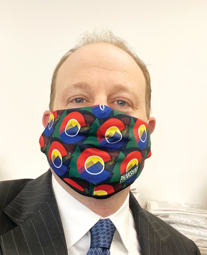 Gov. Jared Polis wears a Colorado-themed mask.