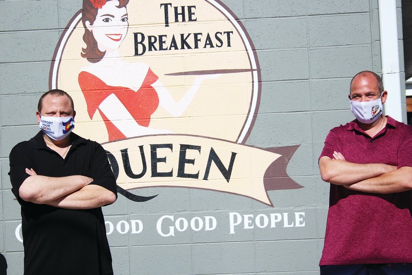 George Vasilas, left, and Kosta Vasilas stand in the back of the Breakfast Queen's building. Kosta said the restaurant is excited about the possibility to offer dine-in-services and said Breakfast Queen needs to expand its outdoor seating.