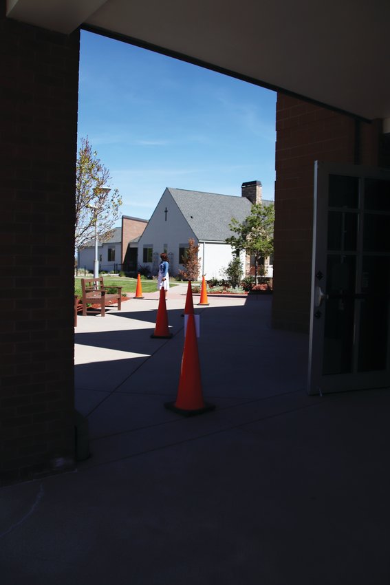 Cones outside of St. Mark's Church indicate the amount of space attendees are required to observe while waiting to enter the building.