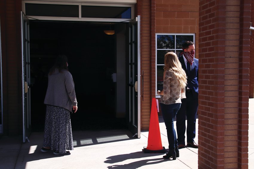 Congregants of St. Mark's Catholic Church wait to enter the parish May 17 for one of the first in-person services since the COVID-19 pandemic began.