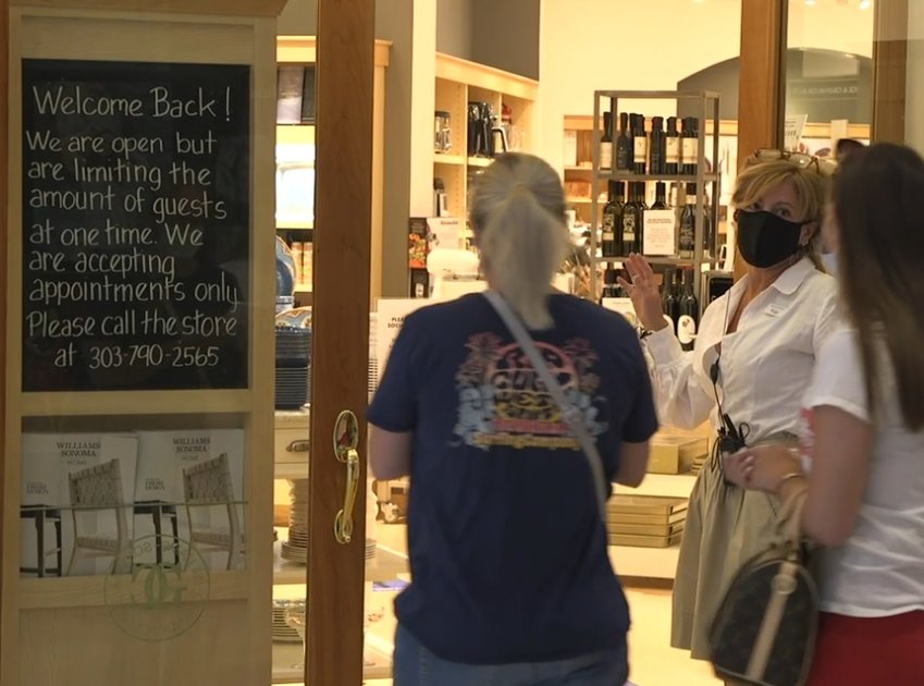 An employee welcomes shoppers into the Williams-Sonoma store at Park Meadows mall in Lone Tree on May 24, 2020.