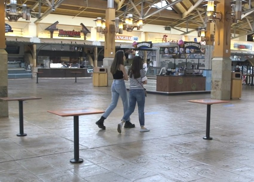 Shoppers stroll through the mostly-empty food court at Park Meadows mall on May 24, 2020.