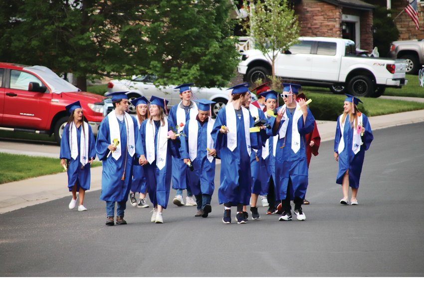 Graduates walk down Unbridled Avenue May 21 in a ceremony hosted by neighbors in Canterberry Crossing.