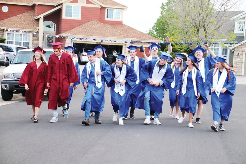 A group of Legend and Ponderosa high school graduates begin their walk down Unbridled Avenue in Parker May 21, a makeshift graduation for the seniors who never got one.
