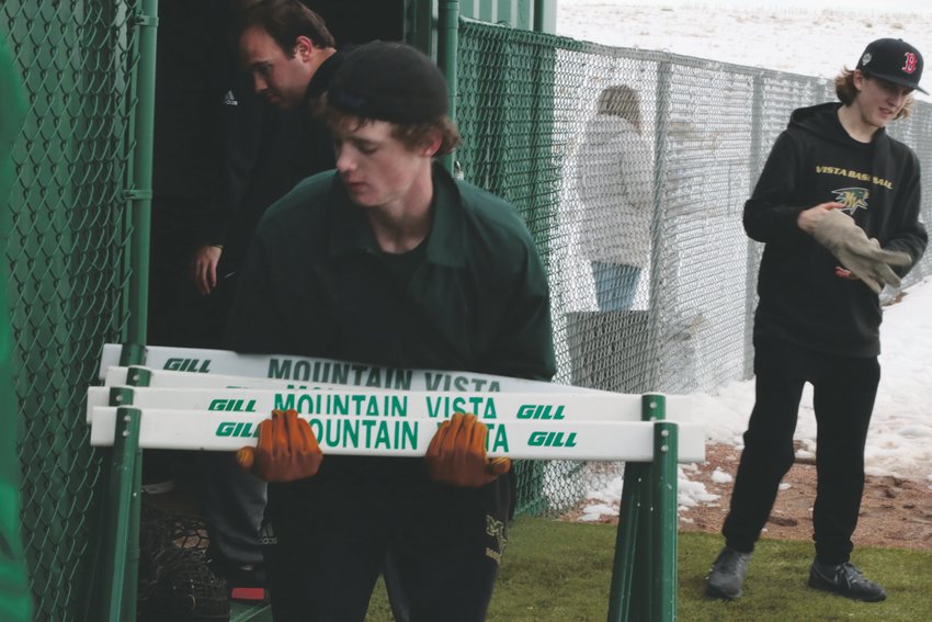 Patrick Boland, 16, helps clean up the Mountain Vista baseball field during a practice in February.