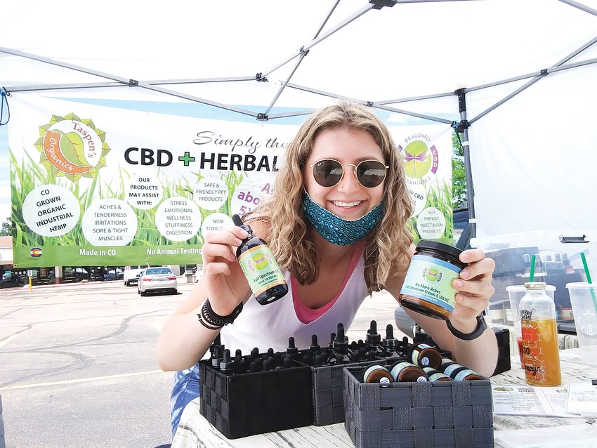 Merisa Trujillo, 20, stands at her booth for Dragonfly Botanicals and Taspen's Organics June 10 at the Centennial Farmers Market. The Lakewood resident has worked farmers markets around the Denver metro area.