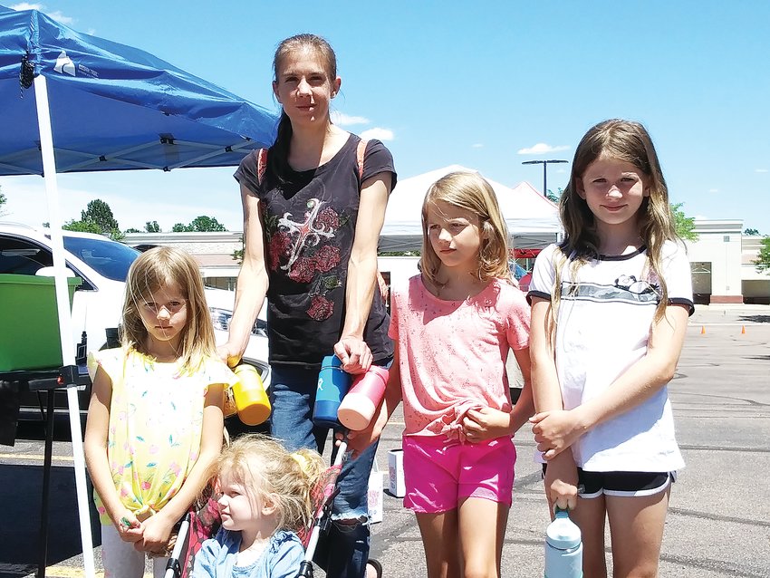 Lexie Satkowski, a 31-year-old Centennial resident, walks with, from left: Eve, 5; Tetra, 3; Sonja, 7; and Una, 9. Satkowski said of the Centennial Farmers Market: "It has everything you need."