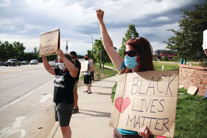 Kelly Mayr, left, and Amy Weeks have participated in multiple protests in Highlands Ranch supporting the Black Lives Matter movement since the death of George Floyd. Here, they are pictured at the corner of Lucent Boulevard and Highlands Ranch Parkway on June 8.
