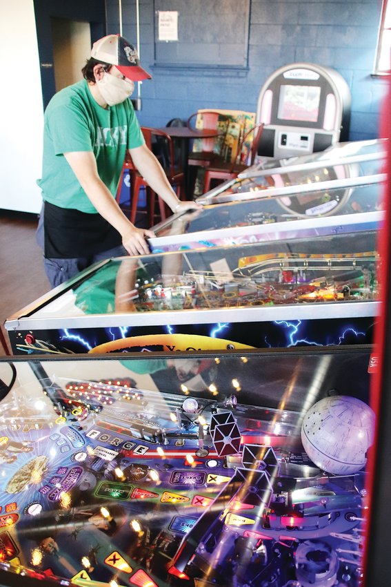 Colorado Pinball Pub co-owner Dan Nikolich takes a break to play a game.