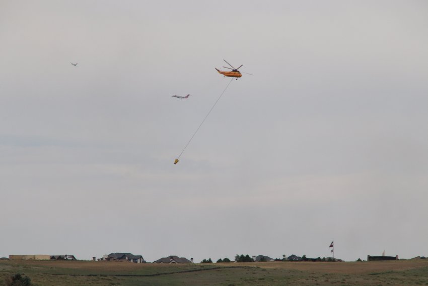 A firefighting helicopter and other aircraft near the Chatridge 2 fire burning in Douglas County on June 29, 2020.